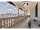 Large balcony with white columns, seating area, and views of the home's pool area at 3931 Pompano Se Dr, St Petersburg, FL 33705
