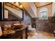 Full bathroom featuring stone floors and wall, granite vanity, and unique arched window at 3931 Pompano Se Dr, St Petersburg, FL 33705