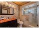 Bathroom featuring an orange countertop, glass shower with stone wall and wooden ceiling at 3931 Pompano Se Dr, St Petersburg, FL 33705