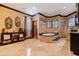 This bathroom features stone walls, a large soaking tub, and dark wood trim at 3931 Pompano Se Dr, St Petersburg, FL 33705
