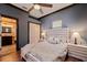 A bedroom featuring a white bed, a glimpse into a Primary bathroom, and a dark blue painted wall at 3931 Pompano Se Dr, St Petersburg, FL 33705