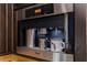 Built-in stainless steel Miele coffee maker with mugs and metallic pitchers at 3931 Pompano Se Dr, St Petersburg, FL 33705