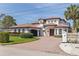 Elegant two-story home with a terracotta tile roof, arched windows, and manicured lawn at 3931 Pompano Se Dr, St Petersburg, FL 33705