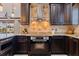 Stylish kitchen showcasing custom cabinets, granite countertops, and a stainless steel oven at 3931 Pompano Se Dr, St Petersburg, FL 33705