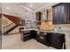 An elegant kitchen boasts granite countertops, stainless steel appliances, and dark wood cabinetry at 3931 Pompano Se Dr, St Petersburg, FL 33705