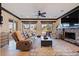 Spacious living room featuring a stone fireplace, comfortable seating, and large windows with outdoor views at 3931 Pompano Se Dr, St Petersburg, FL 33705