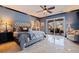 Main bedroom featuring an upholstered headboard, ensuite bath, and patio doors overlooking the outdoor area at 3931 Pompano Se Dr, St Petersburg, FL 33705