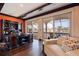 An office with dark wood desk and a large view of the pool and backyard at 3931 Pompano Se Dr, St Petersburg, FL 33705