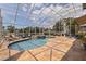 Relax in the spacious lanai with a beautiful pool and lush landscaping at 3931 Pompano Se Dr, St Petersburg, FL 33705