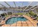 Aerial view of the pool, spa, and outdoor space with boat dock on the canal at 3931 Pompano Se Dr, St Petersburg, FL 33705