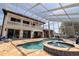 A screened-in outdoor living area features an incredible pool and spa at 3931 Pompano Se Dr, St Petersburg, FL 33705
