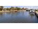 A waterfront view showing a boat dock on the canal of this waterfront property with a bridge in the background at 3931 Pompano Se Dr, St Petersburg, FL 33705