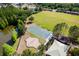 An aerial view showcases the community basketball court, playground, picnic area and pond at 4105 Waterville Ave, Wesley Chapel, FL 33543