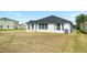 Spacious backyard featuring a lush open space for outdoor activities, surrounded by beautiful landscaping at 4105 Waterville Ave, Wesley Chapel, FL 33543