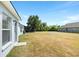 Large backyard features lush landscaping and an open grass area, creating a private outdoor oasis at 4105 Waterville Ave, Wesley Chapel, FL 33543