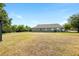 Spacious backyard boasts lush landscaping and a wrought iron fence, creating a private retreat at 4105 Waterville Ave, Wesley Chapel, FL 33543