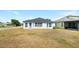 Well-manicured backyard featuring a large open grass area that's ideal for outdoor activities at 4105 Waterville Ave, Wesley Chapel, FL 33543