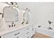 Modern primary bathroom features dual vanities, framed mirrors, and a soaking tub at 4105 Waterville Ave, Wesley Chapel, FL 33543