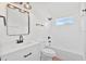 Modern bathroom featuring updated vanity, shower with a white tile backsplash, and an updated light fixture at 4105 Waterville Ave, Wesley Chapel, FL 33543
