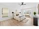 Bright bedroom with hardwood floors, ceiling fan, and bay window sitting area at 4105 Waterville Ave, Wesley Chapel, FL 33543