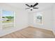 Bright bedroom features hardwood floors, natural light, and two large windows at 4105 Waterville Ave, Wesley Chapel, FL 33543