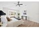 Bright primary bedroom boasts a ceiling fan, bay window, and decorative elements at 4105 Waterville Ave, Wesley Chapel, FL 33543