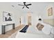 Bright primary bedroom boasts decorative accents, modern ceiling fan and ensuite access at 4105 Waterville Ave, Wesley Chapel, FL 33543