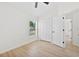 Bright bedroom features wood floors, closet, and a window that provides natural light at 4105 Waterville Ave, Wesley Chapel, FL 33543