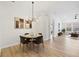 Dining room with modern chandelier and access to living room at 4105 Waterville Ave, Wesley Chapel, FL 33543