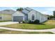 A charming single-story home with a two-car garage, featuring a well-kept lawn and lush landscaping at 4105 Waterville Ave, Wesley Chapel, FL 33543