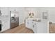 Bright kitchen featuring stainless steel refrigerator, quartz counters, and modern white cabinets at 4105 Waterville Ave, Wesley Chapel, FL 33543