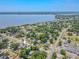 Wide aerial perspective showcasing a home's strategic position amidst lush greenery and close proximity to the waterfront at 503 Chestnut St, Oldsmar, FL 34677