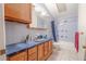 Blue-tiled bathroom with oak vanity and coordinated fixtures at 503 Chestnut St, Oldsmar, FL 34677