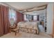 Spacious bedroom with sitting area features wood beams, soft natural light, and neutral carpet at 503 Chestnut St, Oldsmar, FL 34677