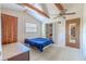 Bright bedroom with wooden beams, ceiling fan, and cozy furnishings at 503 Chestnut St, Oldsmar, FL 34677