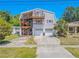 Charming two-story home featuring a unique double-deck design and two-car garage at 503 Chestnut St, Oldsmar, FL 34677