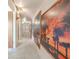Inviting hallway adorned with large sunset artwork and neutral tile flooring at 503 Chestnut St, Oldsmar, FL 34677