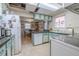 Functional kitchen featuring ample counter space, white appliances, and a cozy breakfast nook at 503 Chestnut St, Oldsmar, FL 34677