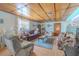 Cozy living room featuring hardwood floors, paneled ceiling, and comfortable furnishings at 503 Chestnut St, Oldsmar, FL 34677