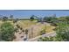 Scenic aerial view of the park with a gazebo, grassy field, trees, and waterfront pier, creating a tranquil community space at 503 Chestnut St, Oldsmar, FL 34677