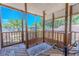 Spacious screened-in porch with wood floors and railings showcases serene views of the surrounding neighborhood at 503 Chestnut St, Oldsmar, FL 34677