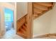 Wood staircase leads to bathroom featuring blue tiled walls, offering functionality and style at 503 Chestnut St, Oldsmar, FL 34677
