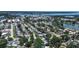 An aerial view shows a neighborhood with mature trees, sidewalks, and convenient access to shopping at 5072 98Th Way, St Petersburg, FL 33708