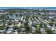 An aerial view shows a neighborhood with mature trees, sidewalks, and convenient access to a nearby pond at 5072 98Th Way, St Petersburg, FL 33708