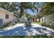 Backyard patio featuring an outdoor dining set, shed, and mature landscaping at 5072 98Th Way, St Petersburg, FL 33708
