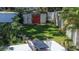 Beautifully landscaped backyard featuring a patio, outdoor dining set, shed, and lush lawn at 5072 98Th Way, St Petersburg, FL 33708