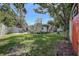 Expansive backyard featuring lush green lawn, a patio, and a storage shed at 5072 98Th Way, St Petersburg, FL 33708
