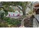 Expansive backyard featuring a lush garden, mature tree, and outdoor seating area at 5072 98Th Way, St Petersburg, FL 33708