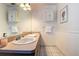 Well-lit bathroom with double sinks and decorative cabinetry at 5072 98Th Way, St Petersburg, FL 33708