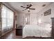 Cozy bedroom with a ceiling fan, hardwood floors, and bright natural lighting at 5072 98Th Way, St Petersburg, FL 33708